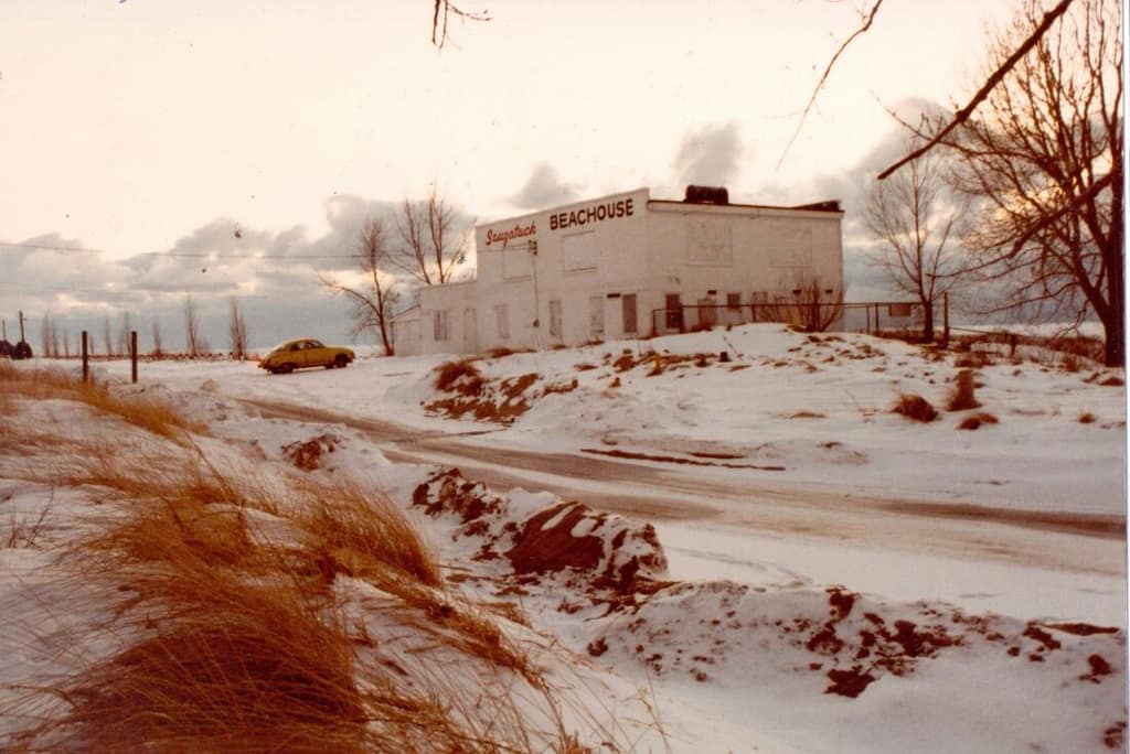 Historic photo of the Oval Beach dunes and bathhouse in winter