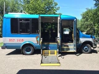 A blue Interurban bus with its wheelchair lift lowered